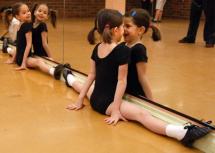 Don Denton/Victoria News staff
Seven year old Olivia Brown makes a face at herself in the mirror as she stretches during her dance class for the Junior Apprentice Company at Dance Unlimited. Looking on at left is her twin Georgia.